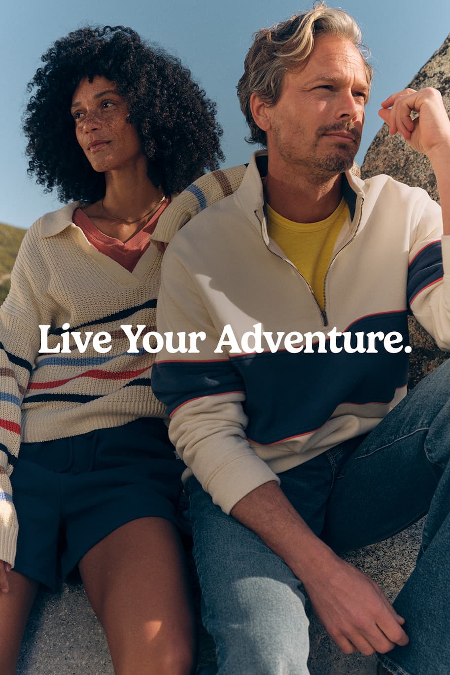 Man and Women in Outdoor Gear sitting in back of car. 