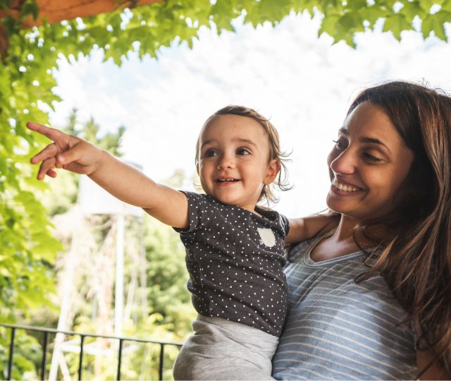 Mom holding her child who is pointing