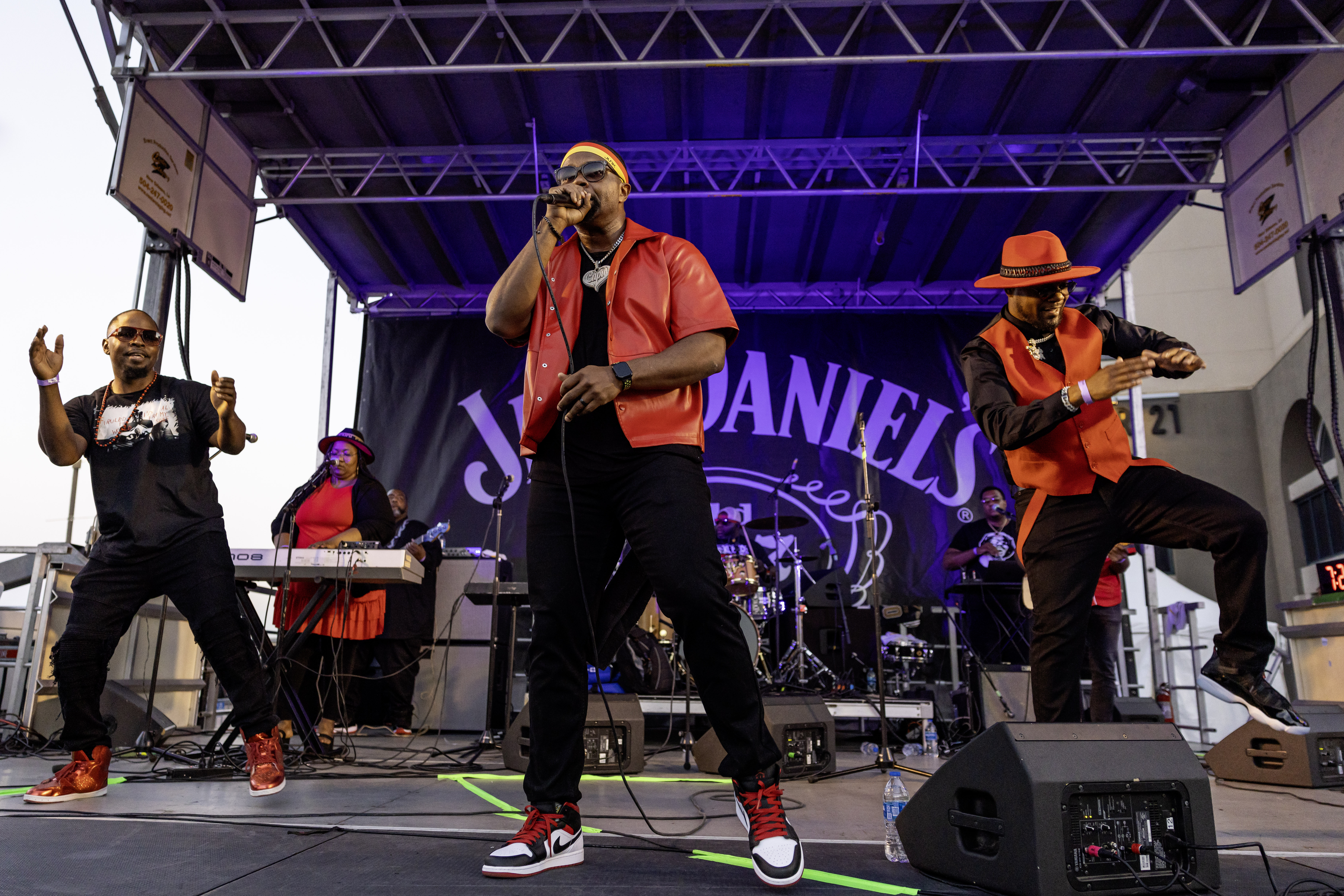 a group of men on a stage singing and playing instruments