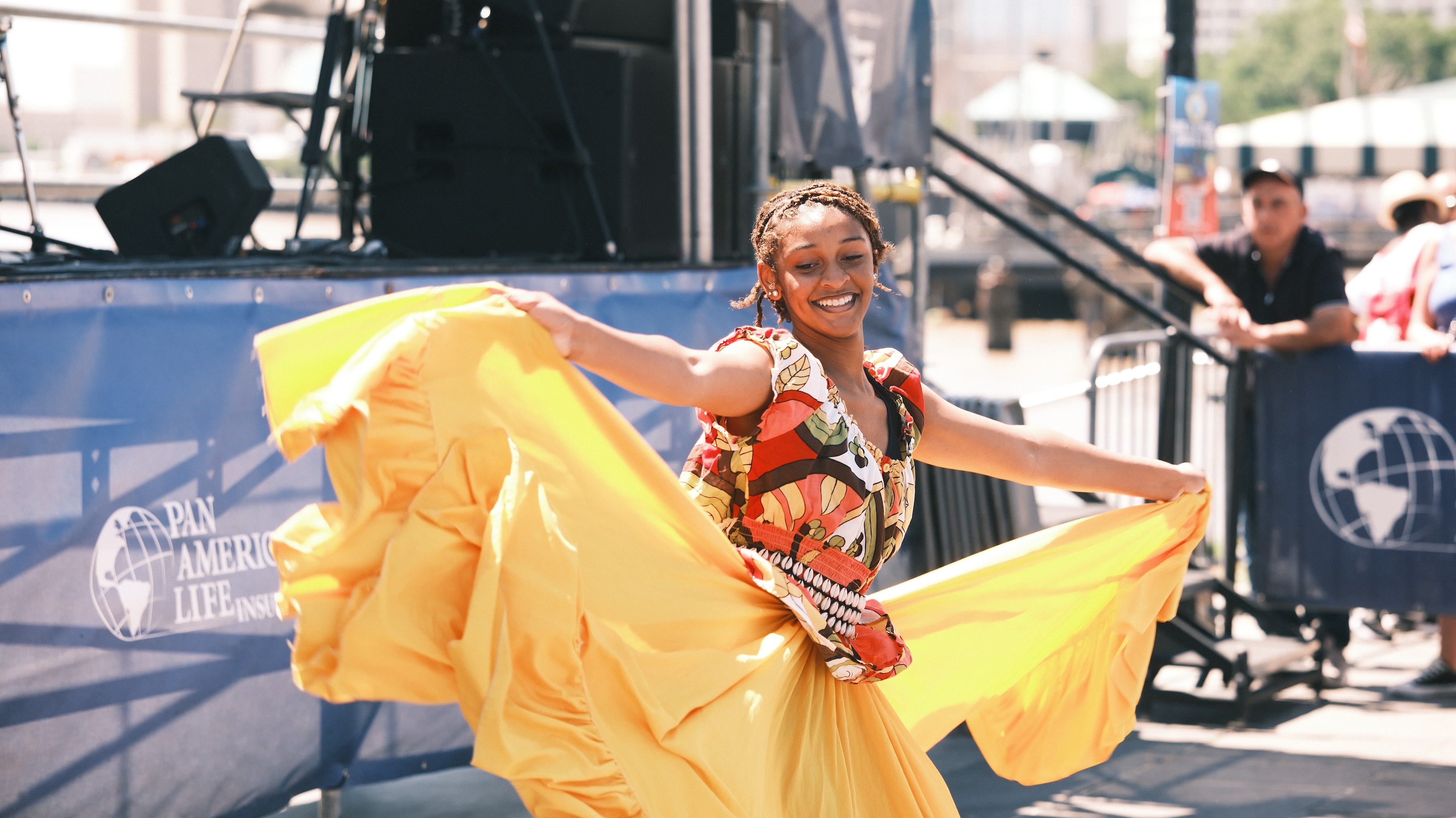 a woman in a yellow dress holding up a yellow skirt