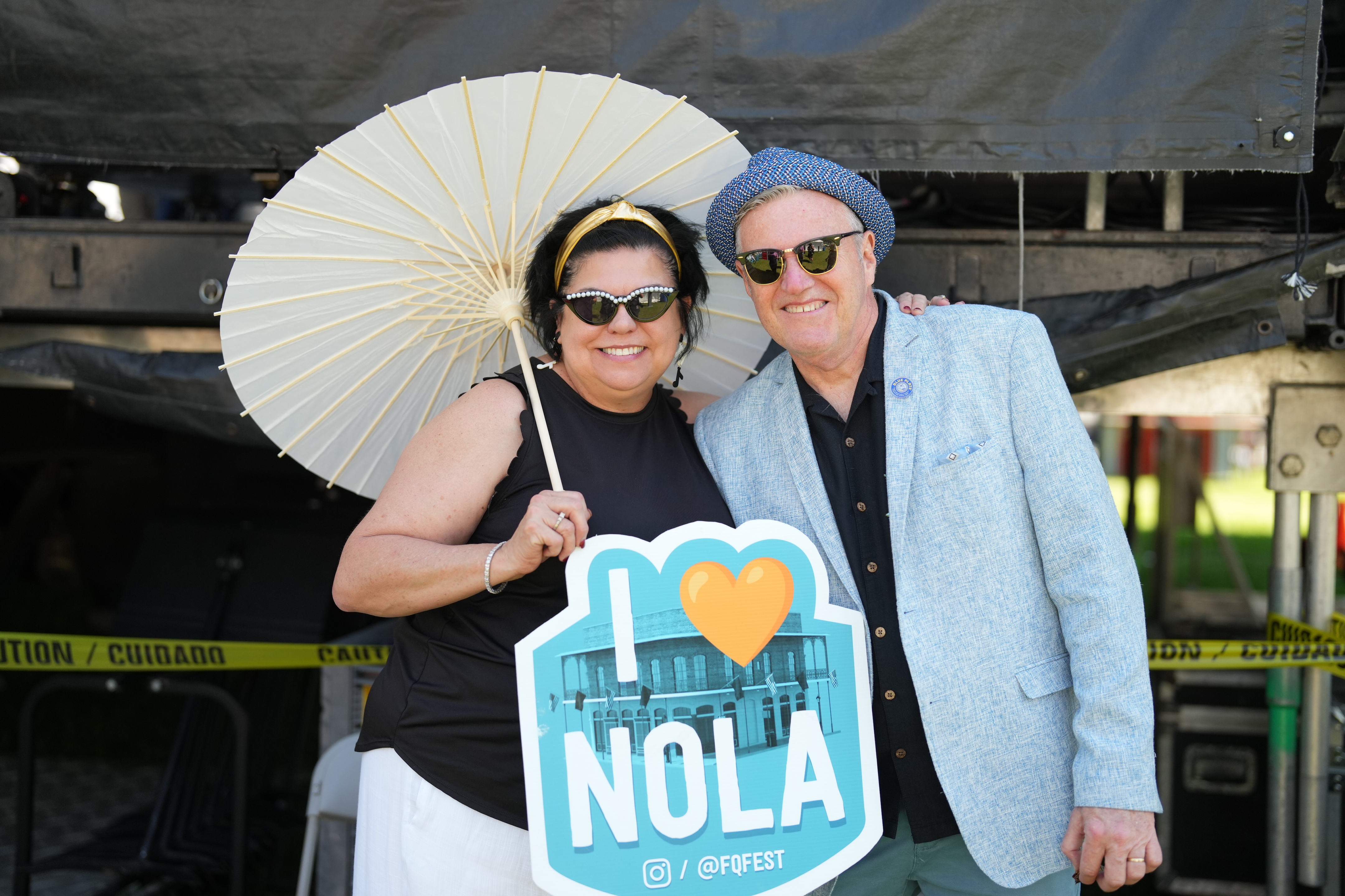two people holding an "I Love NOLA" sign