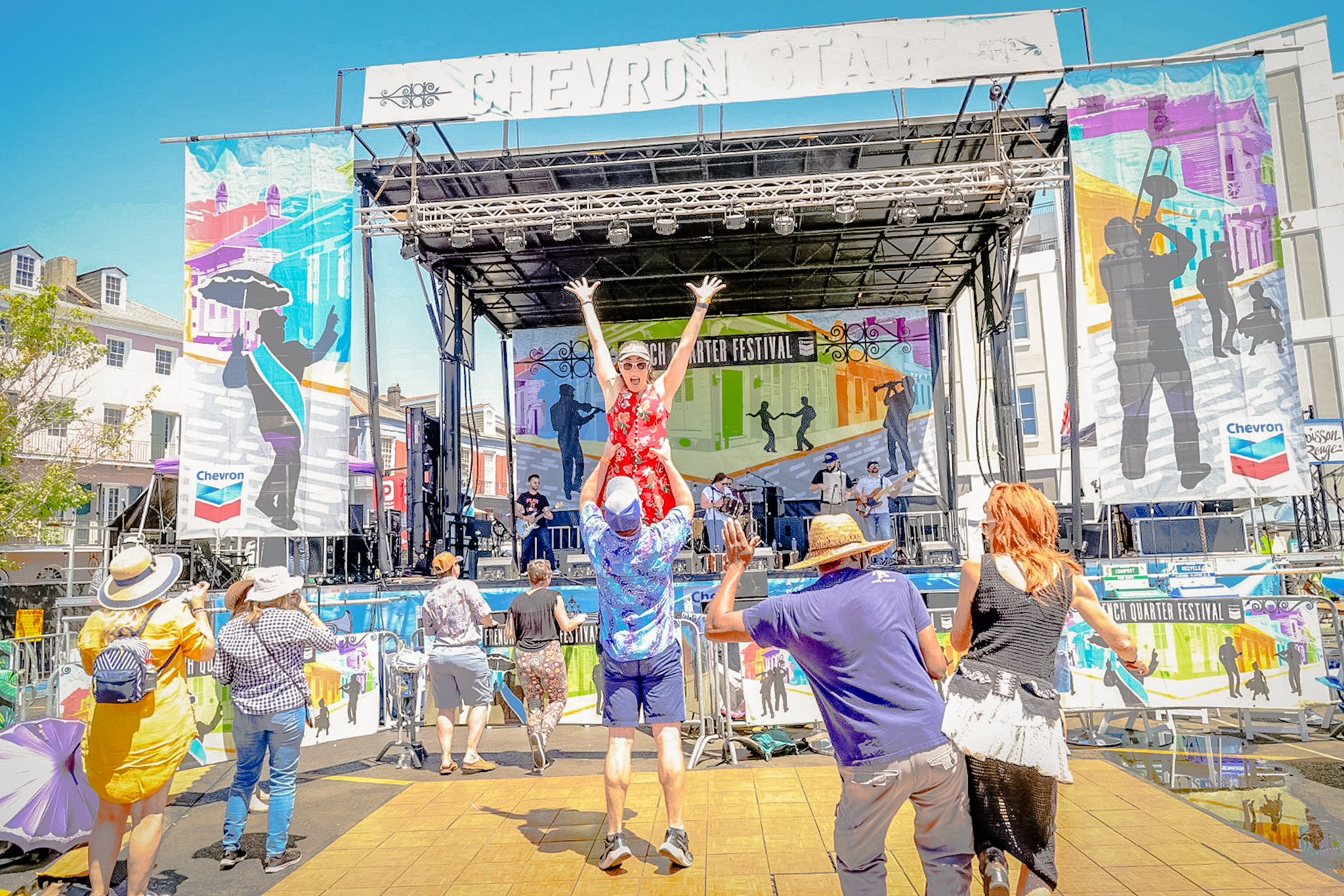 people are taking pictures of a performer on the stage of the chevron stage
