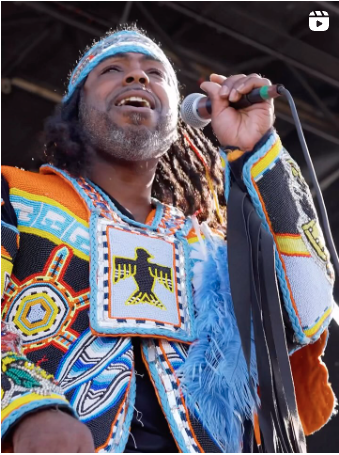 person on stage singing into a microphone