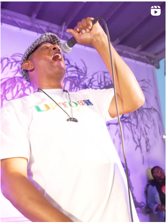 a man singing into a microphone on a stage