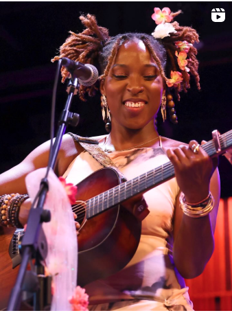 image may contain  person  smiling  playing a musical instrument and on stage