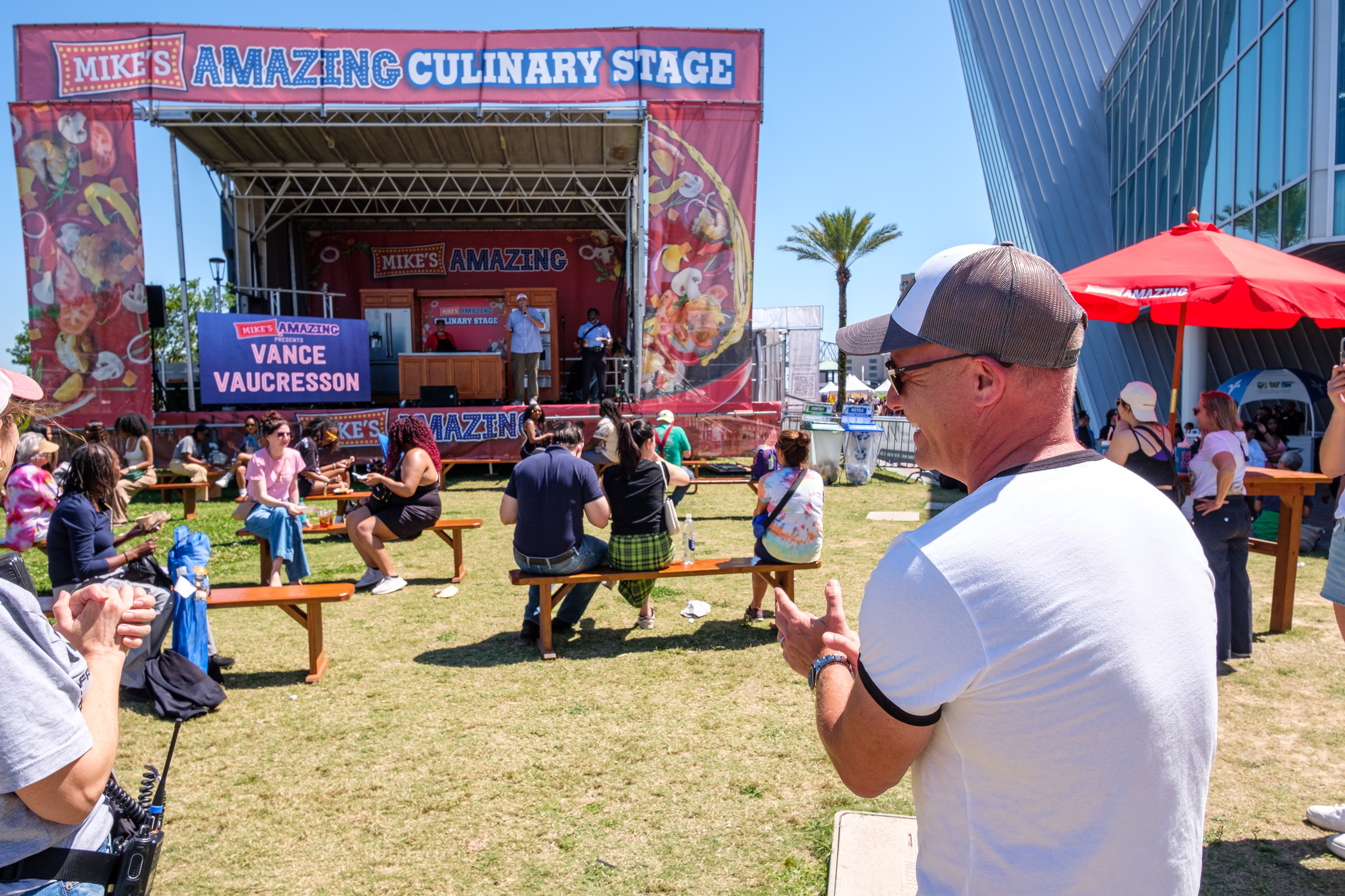 a man standing in front of a stage at a festival