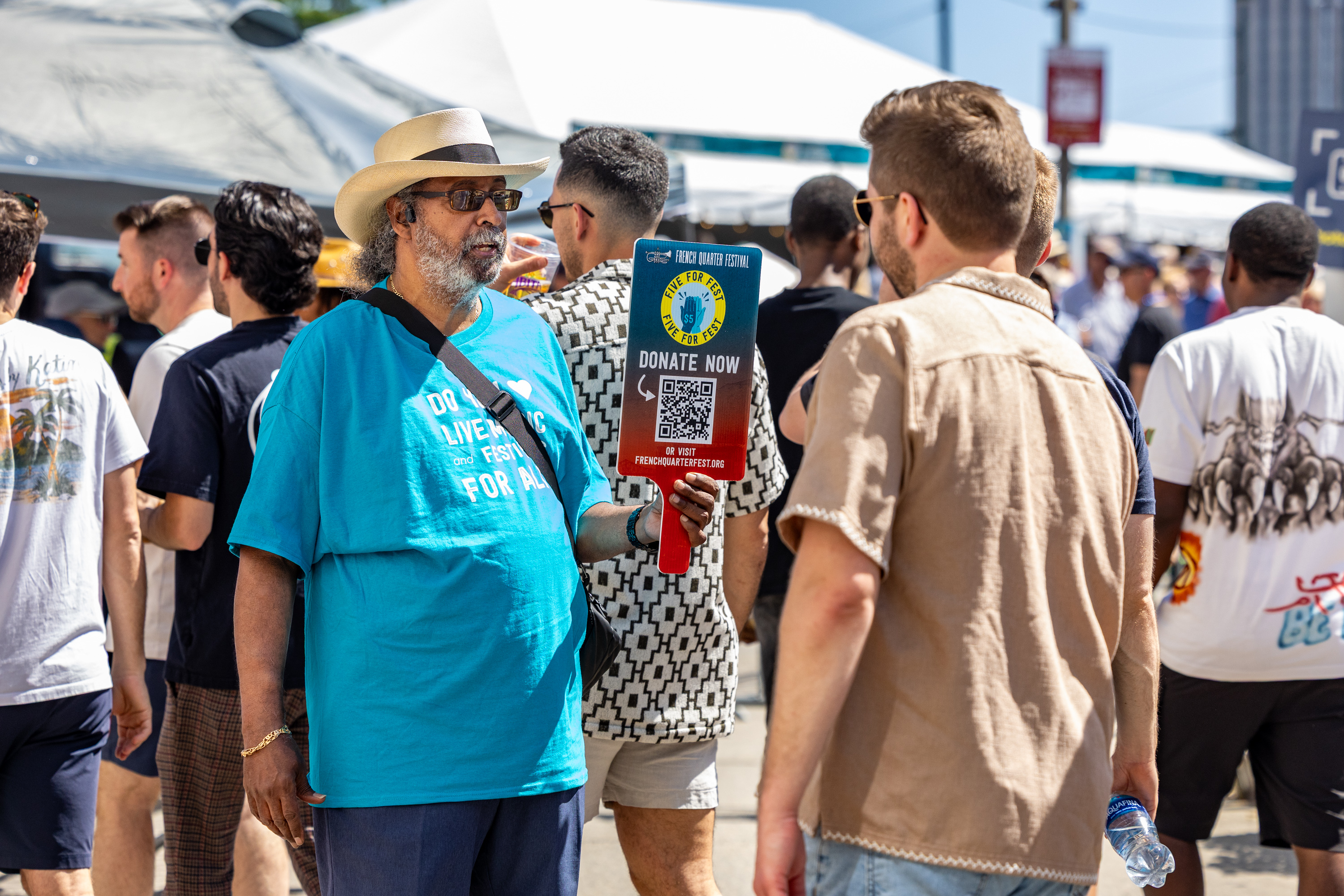 two people holding an "I Love NOLA" sign