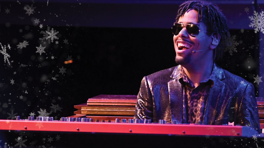 matthew whitaker playing the keyboard on a stage