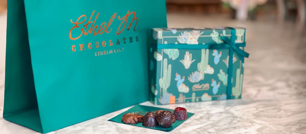 Ethel M Chocolates Custom Chocolate Box and Chocolate Gems on a napkin.