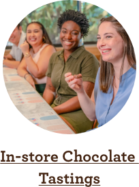 Two women enjoying a chocolate tasting at an Ethel M Chocolates store.