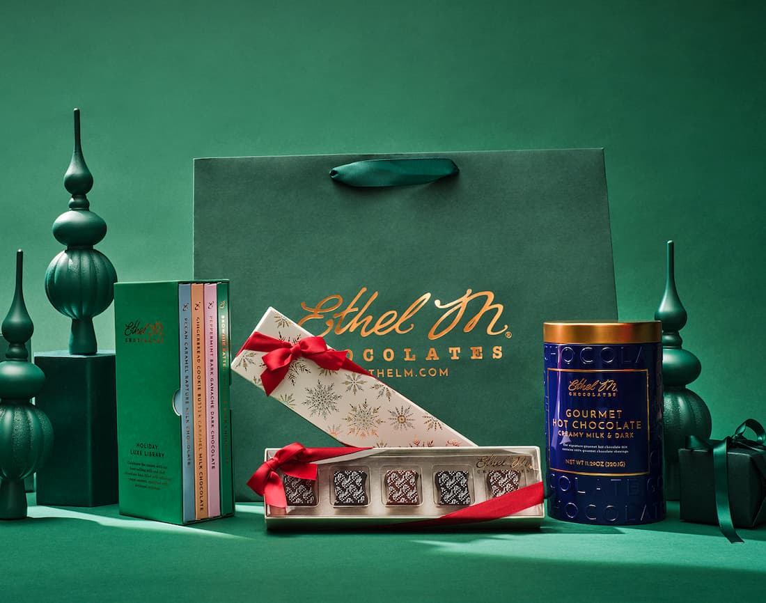 Ethel M Chocolates 2025 Holiday Collection. This image shows the family of products including the Luxe Library, Holiday Creamy Caramels Sampler, and our Gourmet Hot Chocolate.