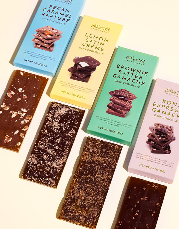 All four Luxe Library bars shot vertical to show the packaging and gourmet bars out of the box.