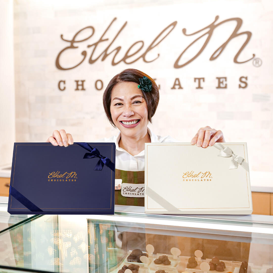 Store Associate serving Ethel M Chocolates at the counter.