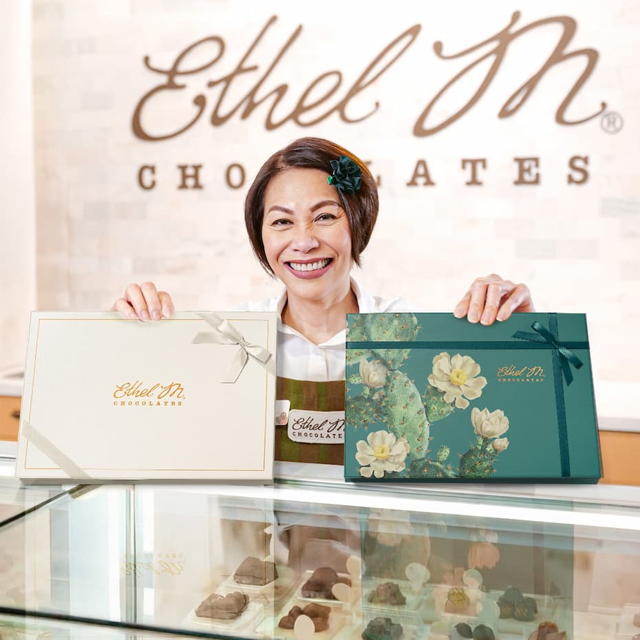 Store Associate serving Ethel M Chocolates at the counter.