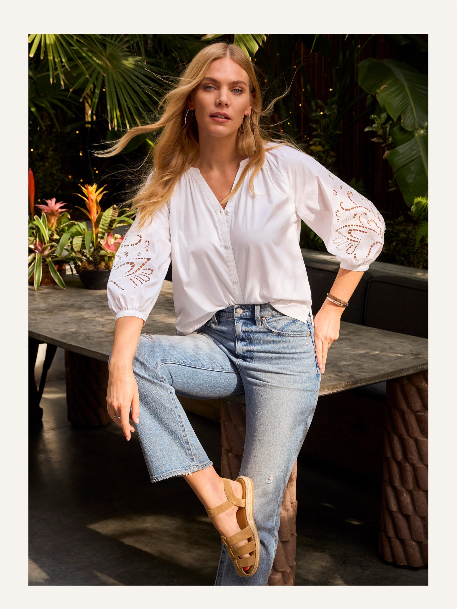 Image of woman in white button down top.