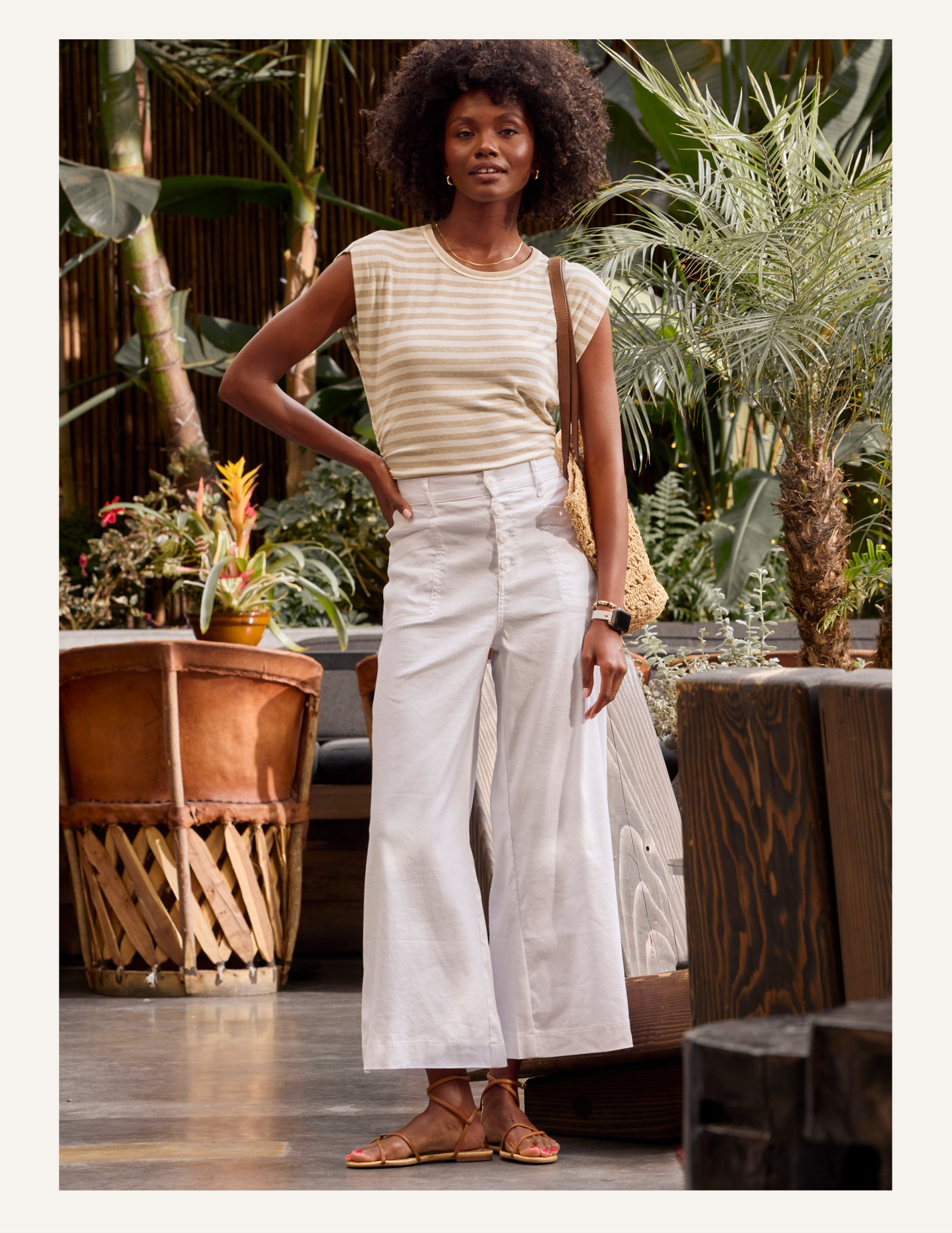 Image of woman in white flared pants. 