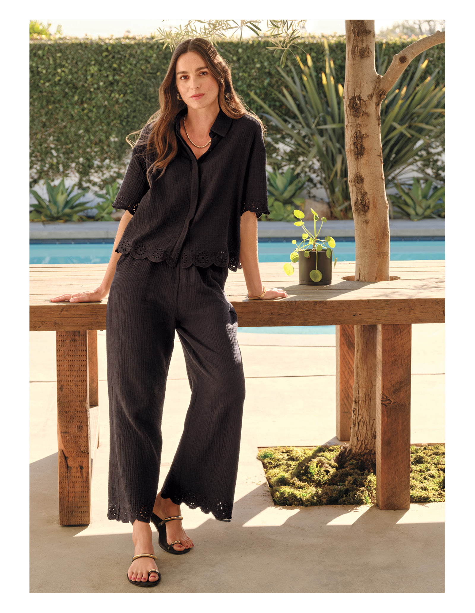 Image of woman in black eyelet set. 