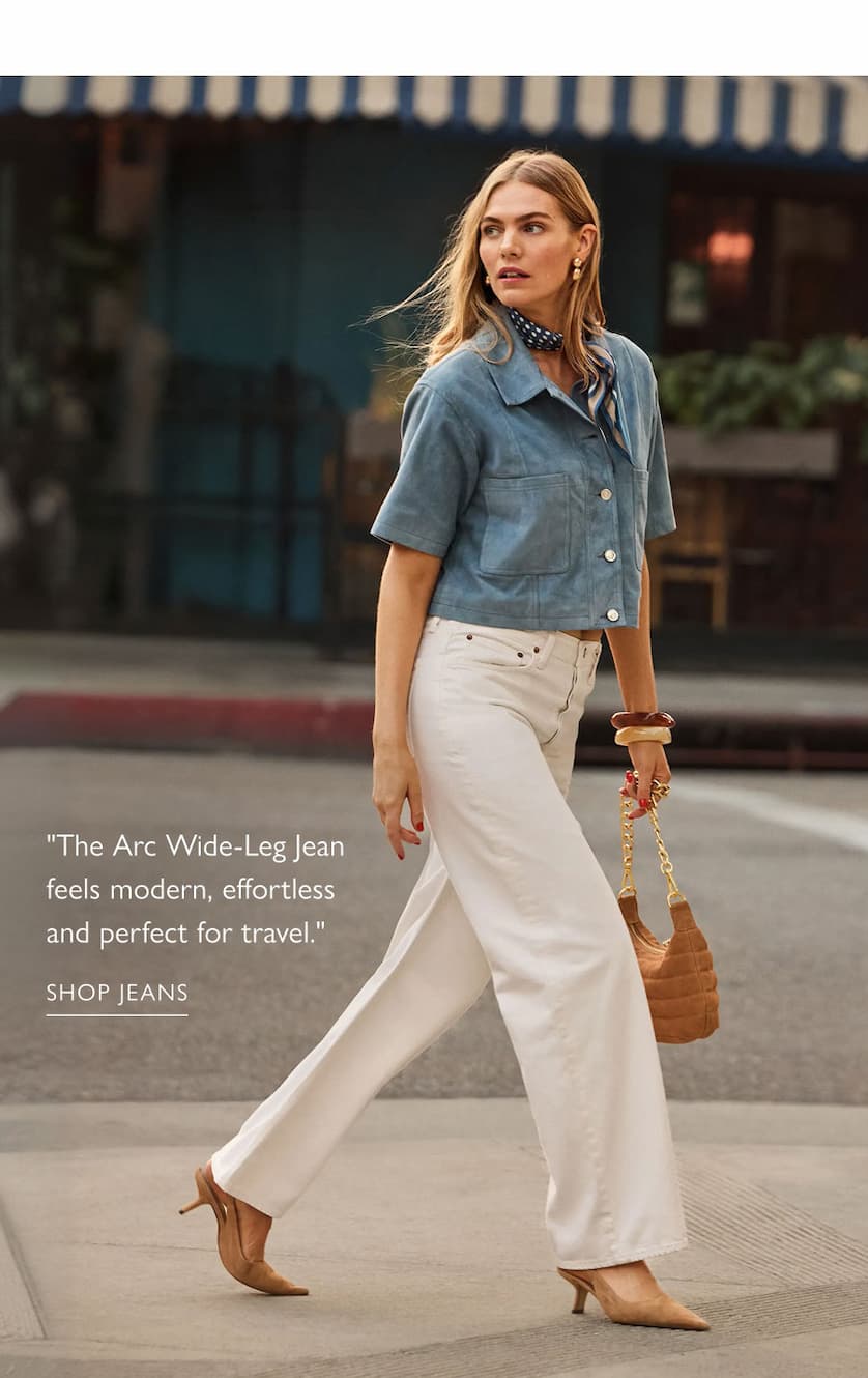 "The Arc Wide-Leg Jean feels modern, effortless and perfect for travel." Image of model in white wide-leg jeans. SHOP JEANS