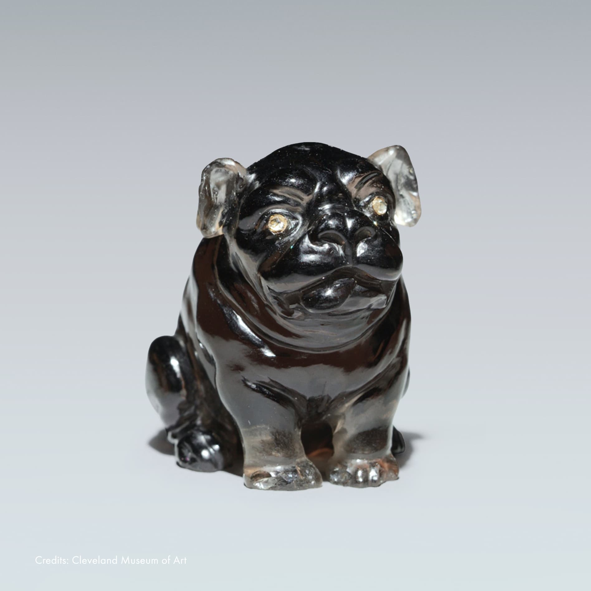 Fabergé bulldog decorative object crafted from carved hardstone, featuring a black body, translucent crystal accents and gemstone-set eyes, showcasing the Maison's renowned artistry and craftsmanship.
