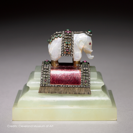 Fabergé elephant decorative object crafted from carved moonstone, featuring jeweled trappings in diamonds, rubies, and emeralds on a pink enamel and hardstone base, showcasing the House's renowned artistry and craftsmanship.