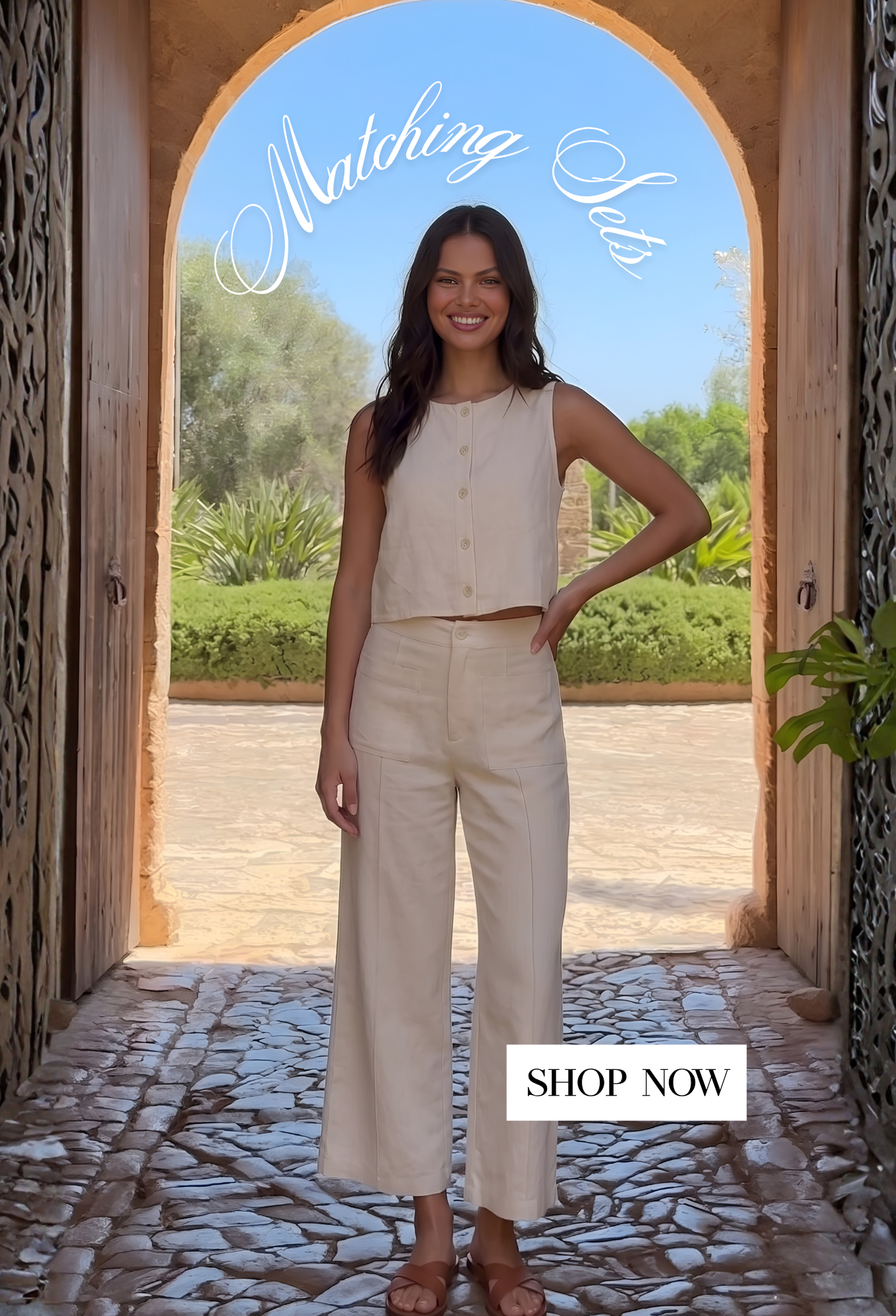 an image of a woman leaning against a wall with a cherry tree in the background