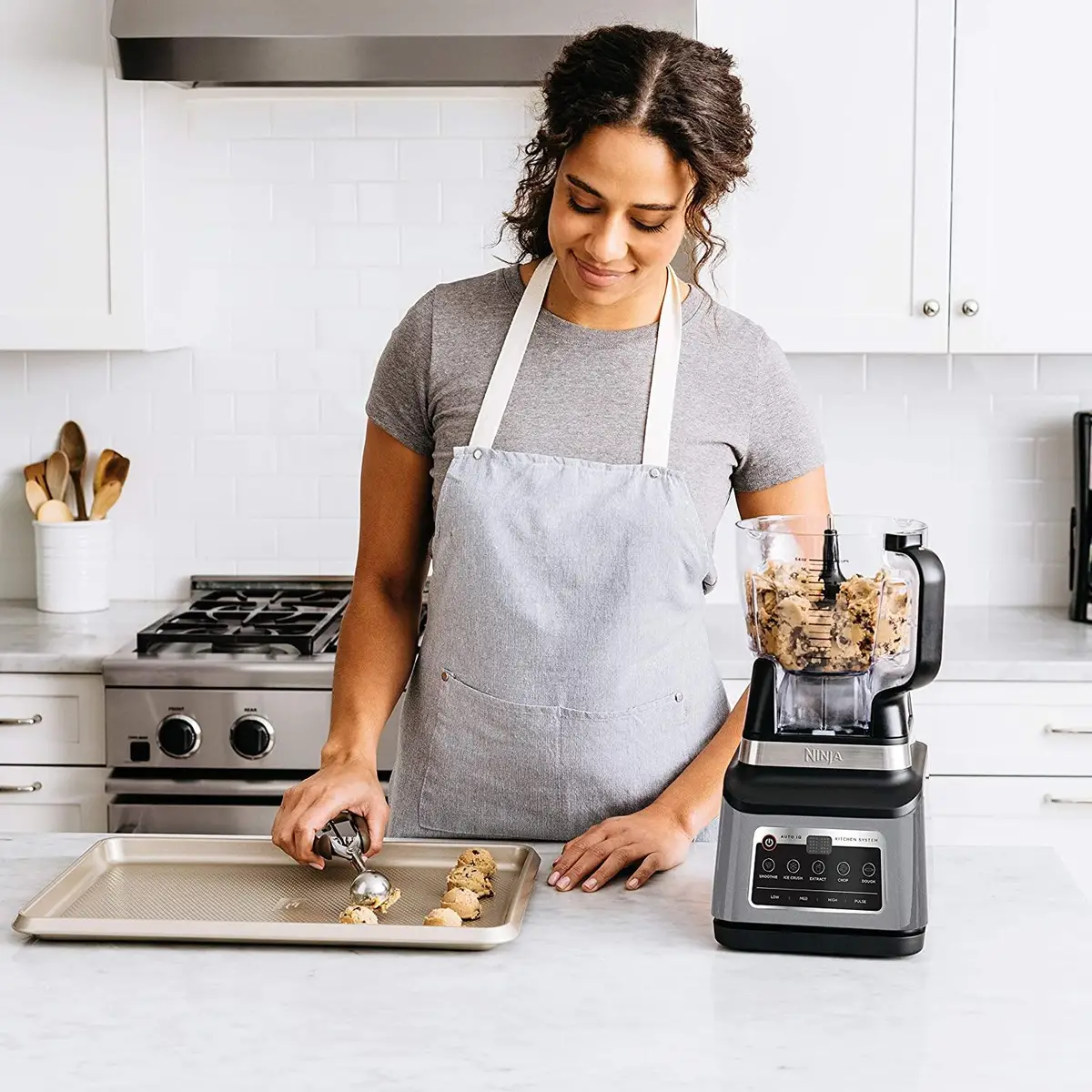 Woman making cookie dough in a ninja mixer