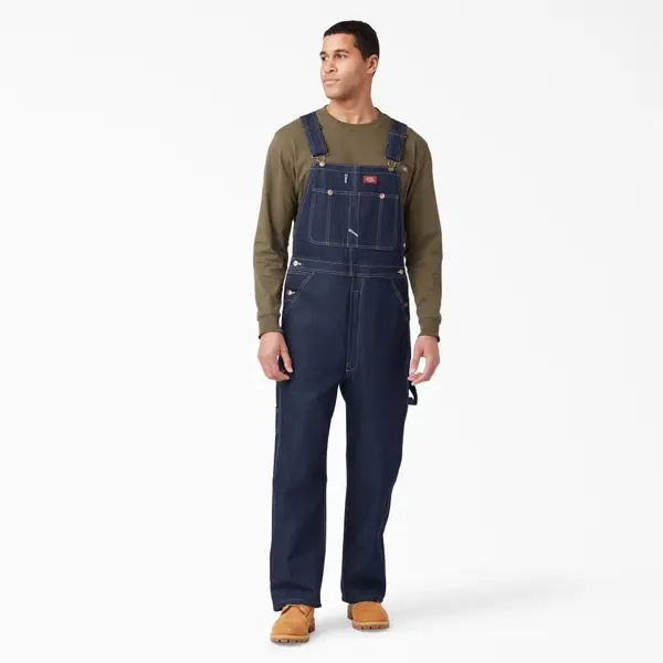 Man wearing jean overalls and a green long-sleeve shirt