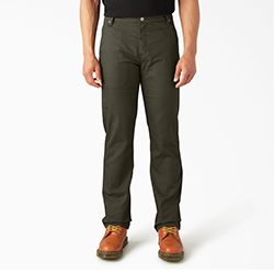 Waist down image of man wearing Dickies dark green carpenter pants