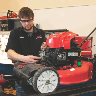 Man servicing lawn mower
