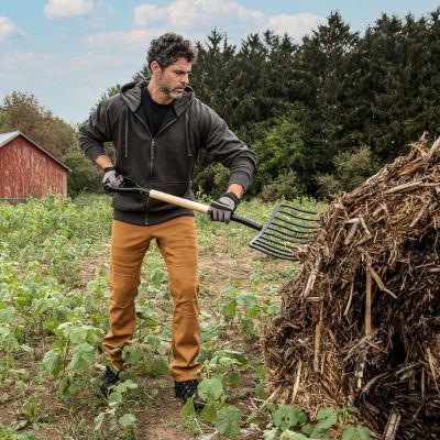 Man in workwear doing work on the farm