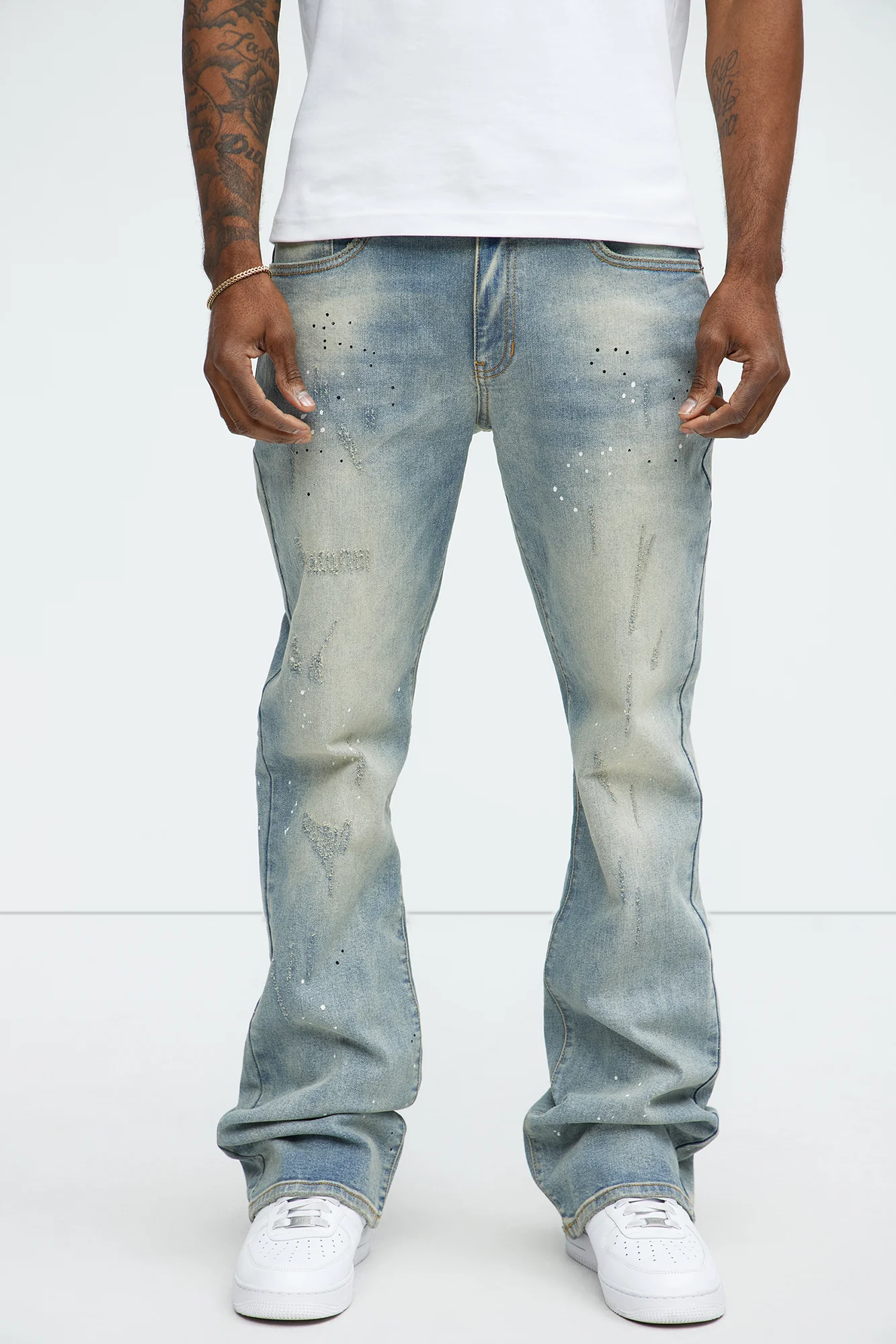 Image of Ripped And Bleach Splatter Stacked Slim Flare Jeans - Light Blue Wash