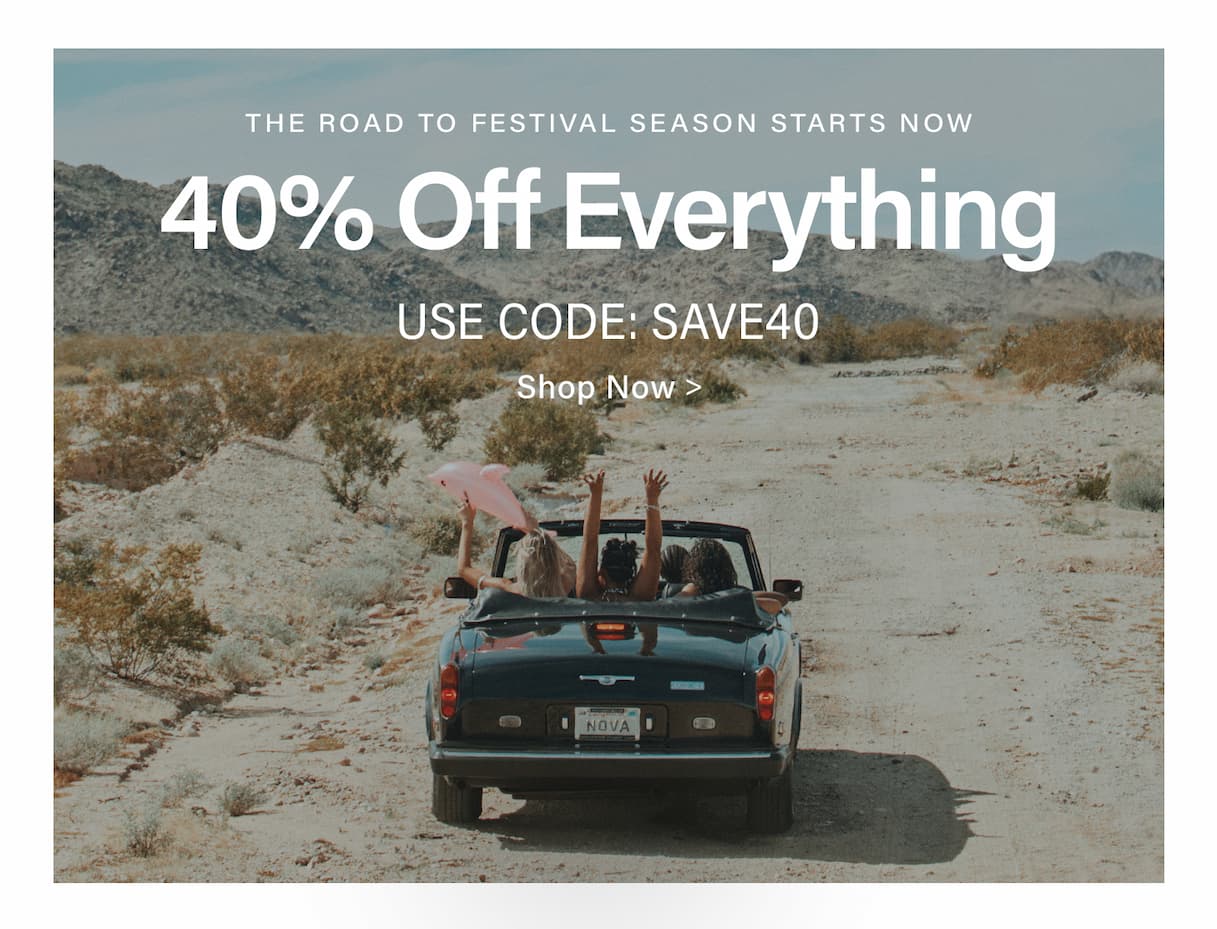 People celebrating festival season in a black convertible on a desert road, promoting a 40% off sale on everything with code SAVE40.