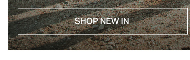 Rough, earthy brown and beige ground texture with a white 'SHOP NEW IN' button. Click to discover new collection items and latest arrivals.