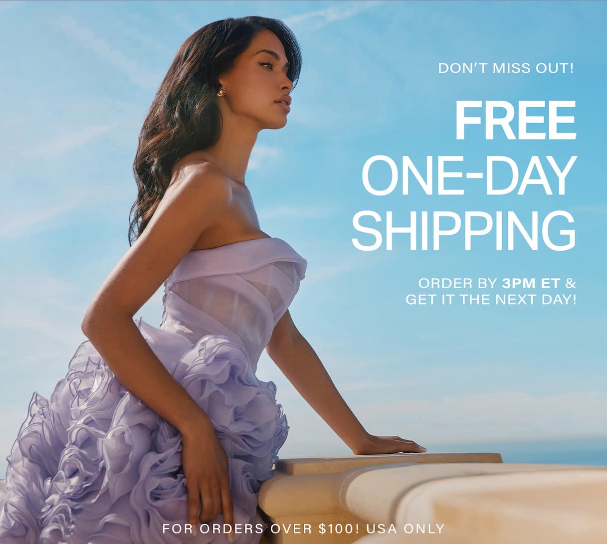 Woman in a lavender ruffled strapless dress leaning on a balcony railing against a blue sky, promoting free one-day shipping on women's fashion.