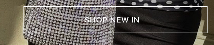 Sparkling silver-tone top paired with a black outfit featuring a polka dot detail, inviting users to shop the latest new arrivals.