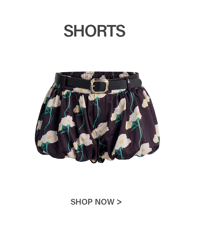 Puffed black shorts with white floral print, green stems, and a black belt with a gold buckle. Shop our stylish summer shorts.