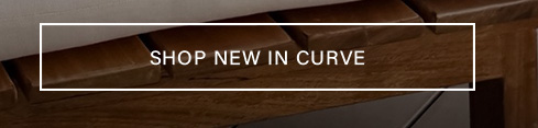 Dark brown wood texture with a light gray top edge, featuring a white text box: "SHOP NEW IN CURVE" to discover new plus size clothing.