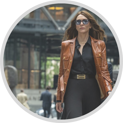Cate Blanchett walks through a train station wearing a brown leather coat and sunglasses in Black Bag