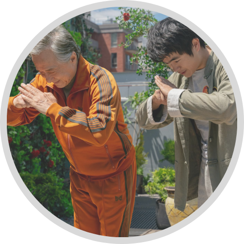 Jackie Chan, Ben Wang bowing in a rooftop garden-1