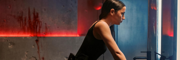 Ana de Armas, bloodstained, looking at her reflection in the mirror in From the World of John Wick Ballerina