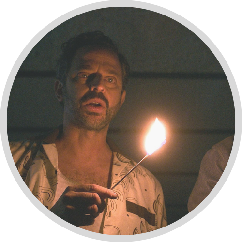 Image of a man holding a match in a dark room (1)