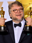 Image of Guillermo Del Toro holding 2 Oscars