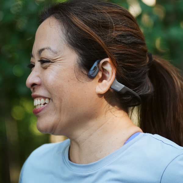 Woman wearing Shokz headphones