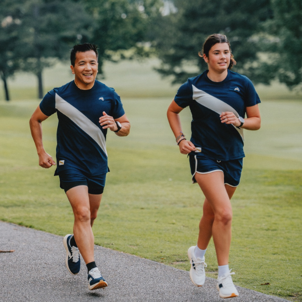Man and woman wearing Tracksmith shoes and appaeal