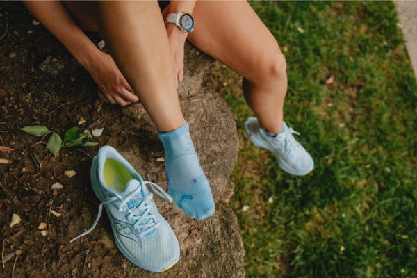 Woman wearing socks and saucony shoes