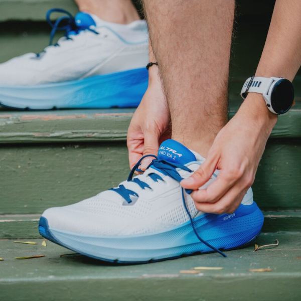 Man tying Altra shoes