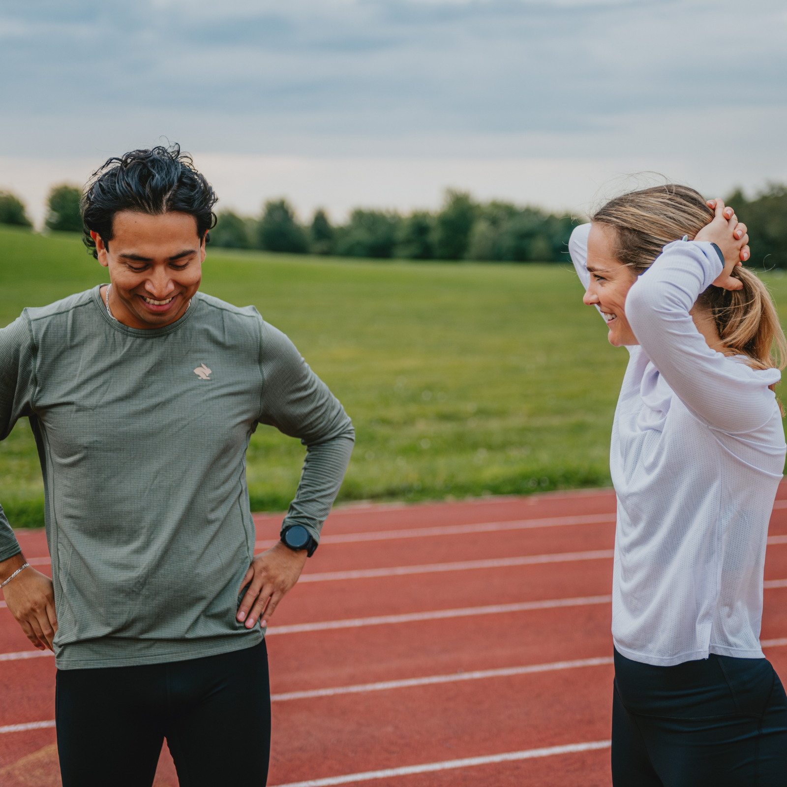 Two runners standing on a track