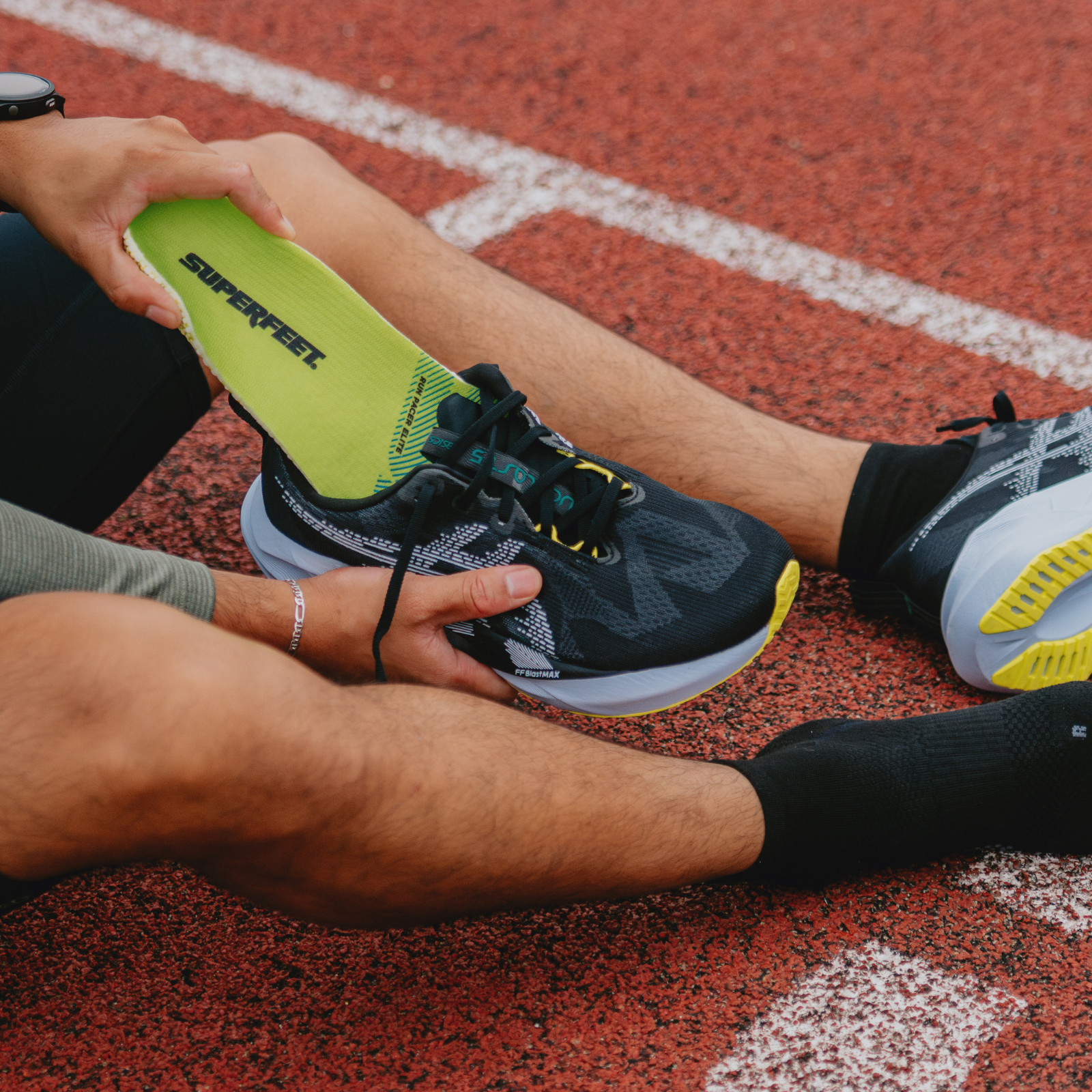 Runner putting superfeet insoles into shoes