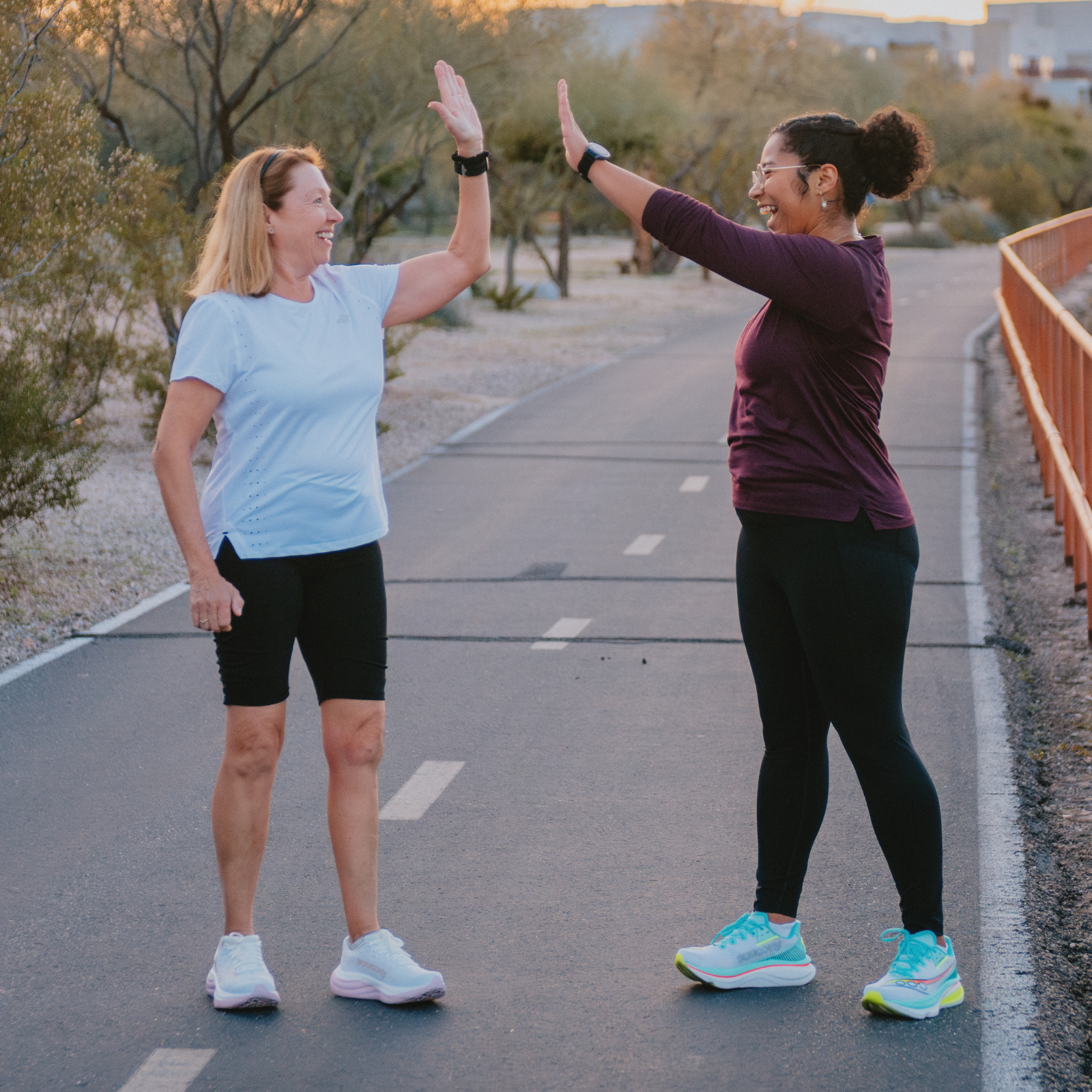 Two women high-fiving