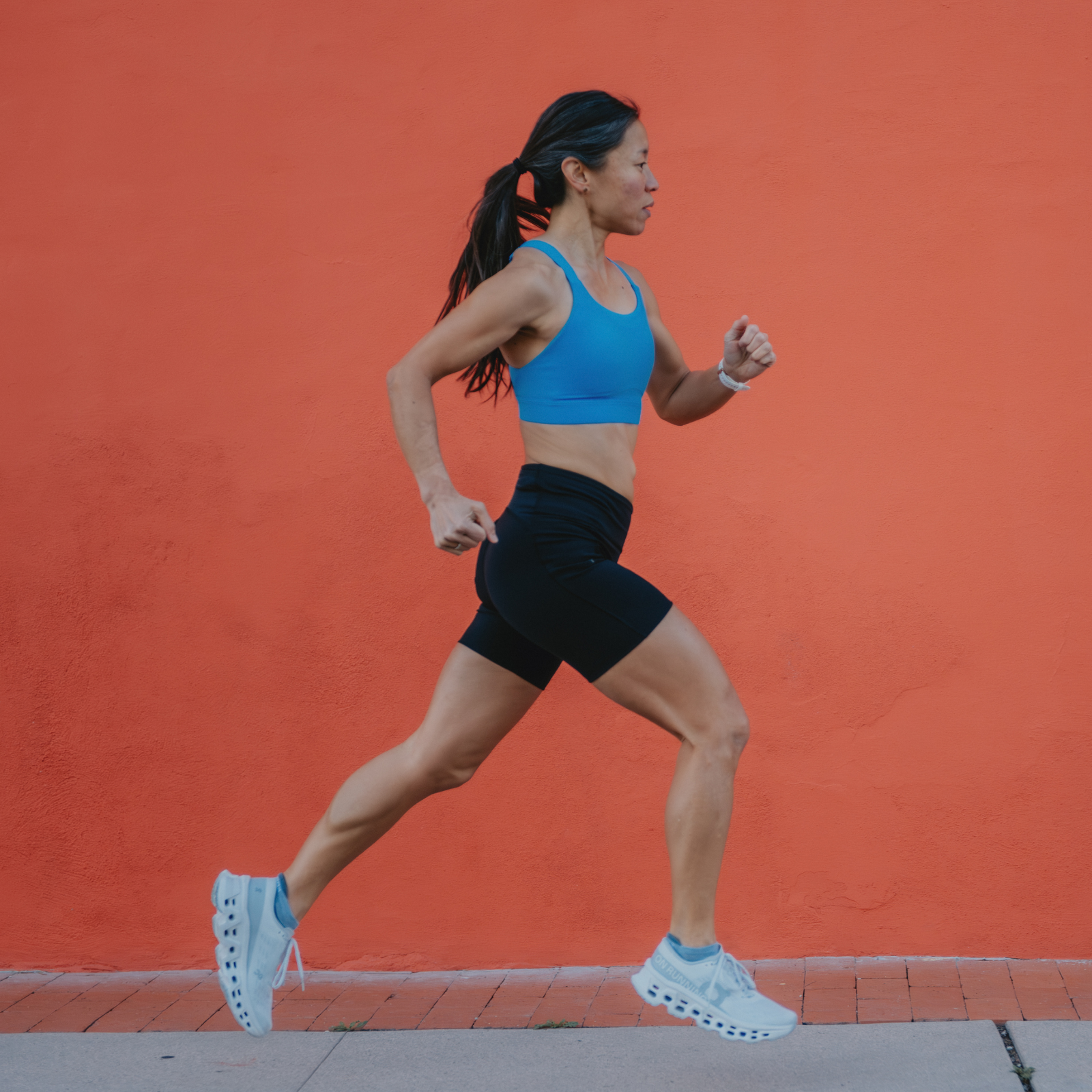 Woman running in On apparel and shoes